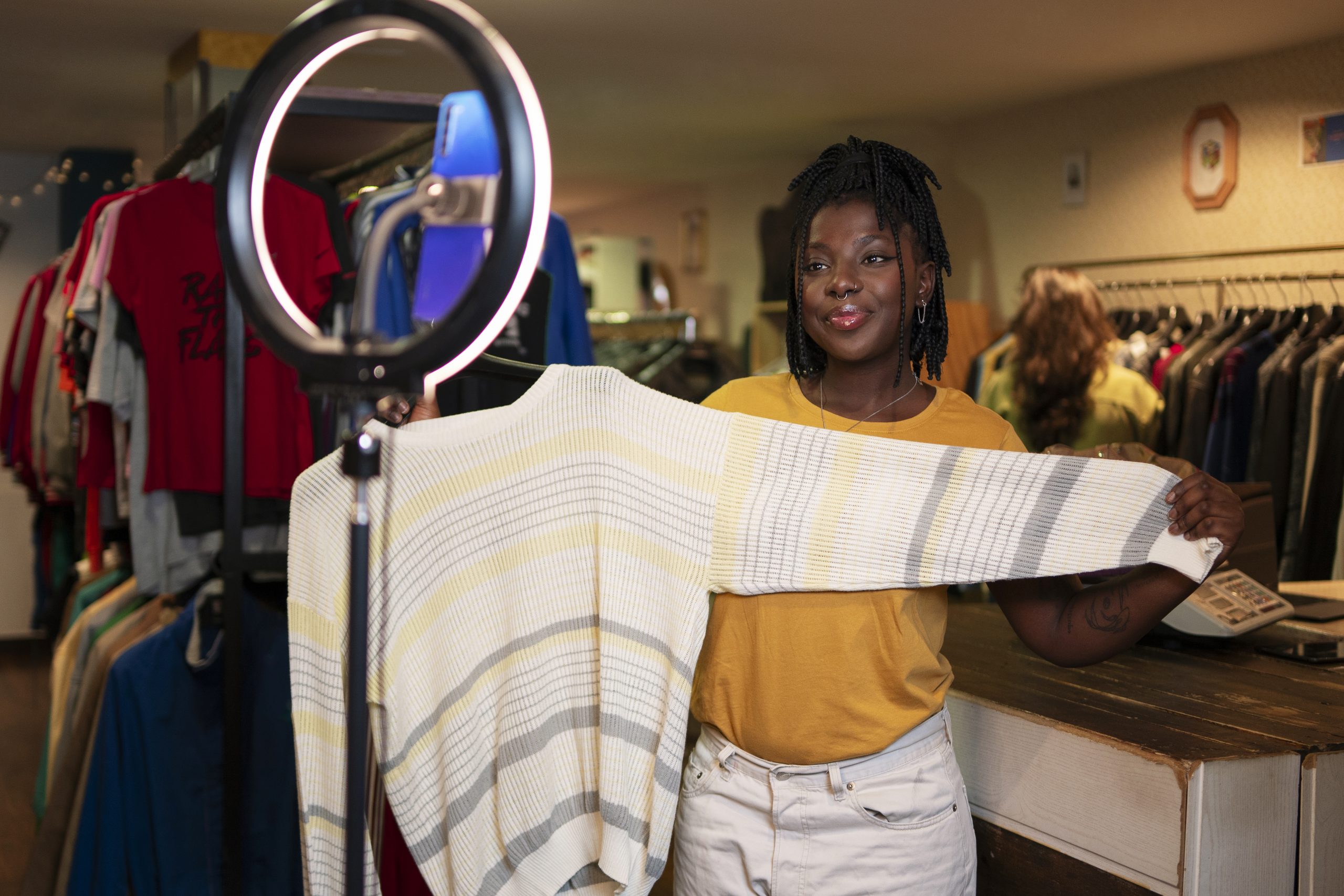 woman-promoting-cloths-from-thrift-store